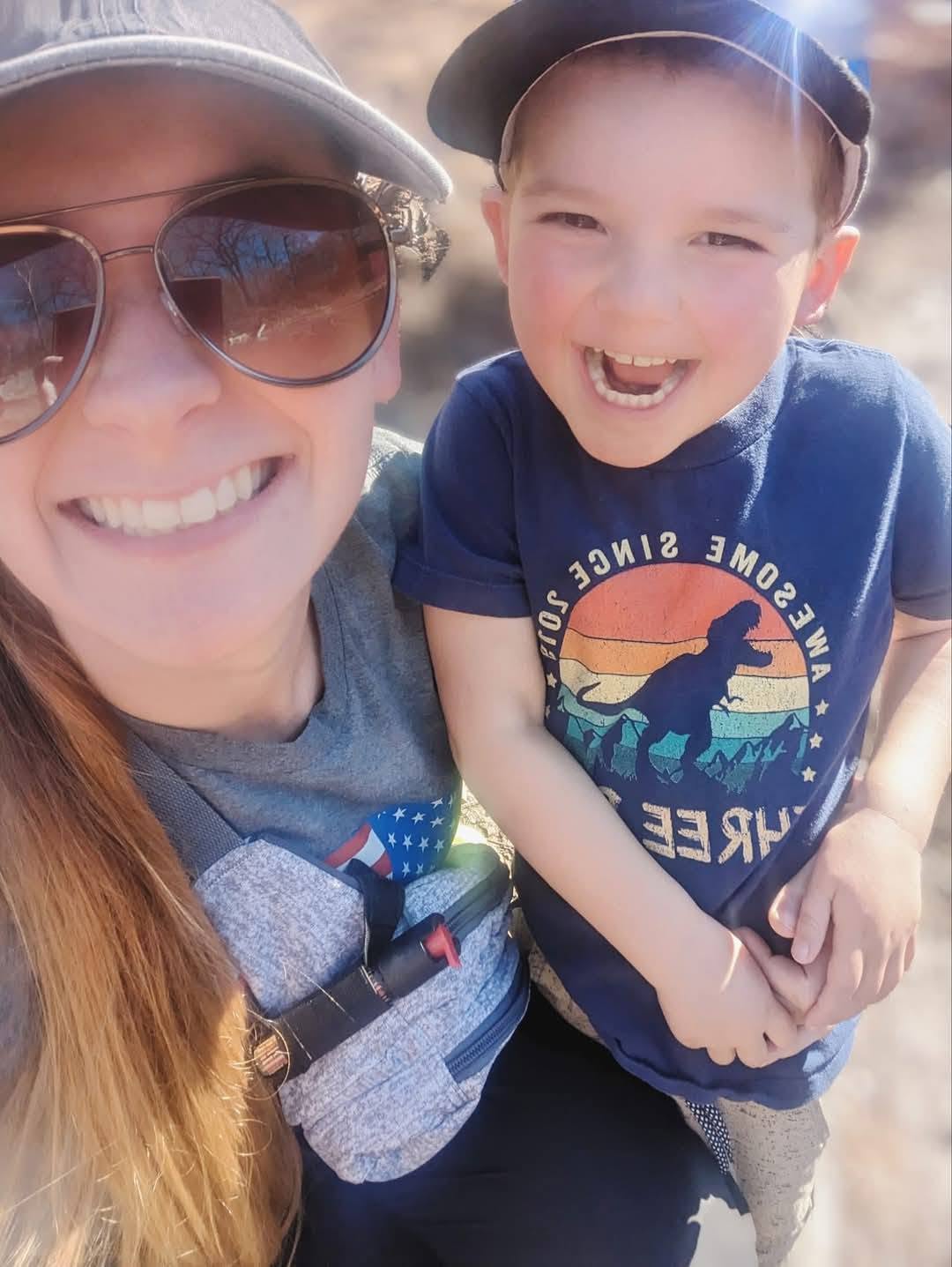 Jessica smiling with her son in matching ballcaps